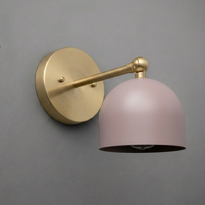 Wall sconce with brushed brass arm and round base, featuring matte pink dome-shaped shade. - SCONCE MODEL NO. 5103