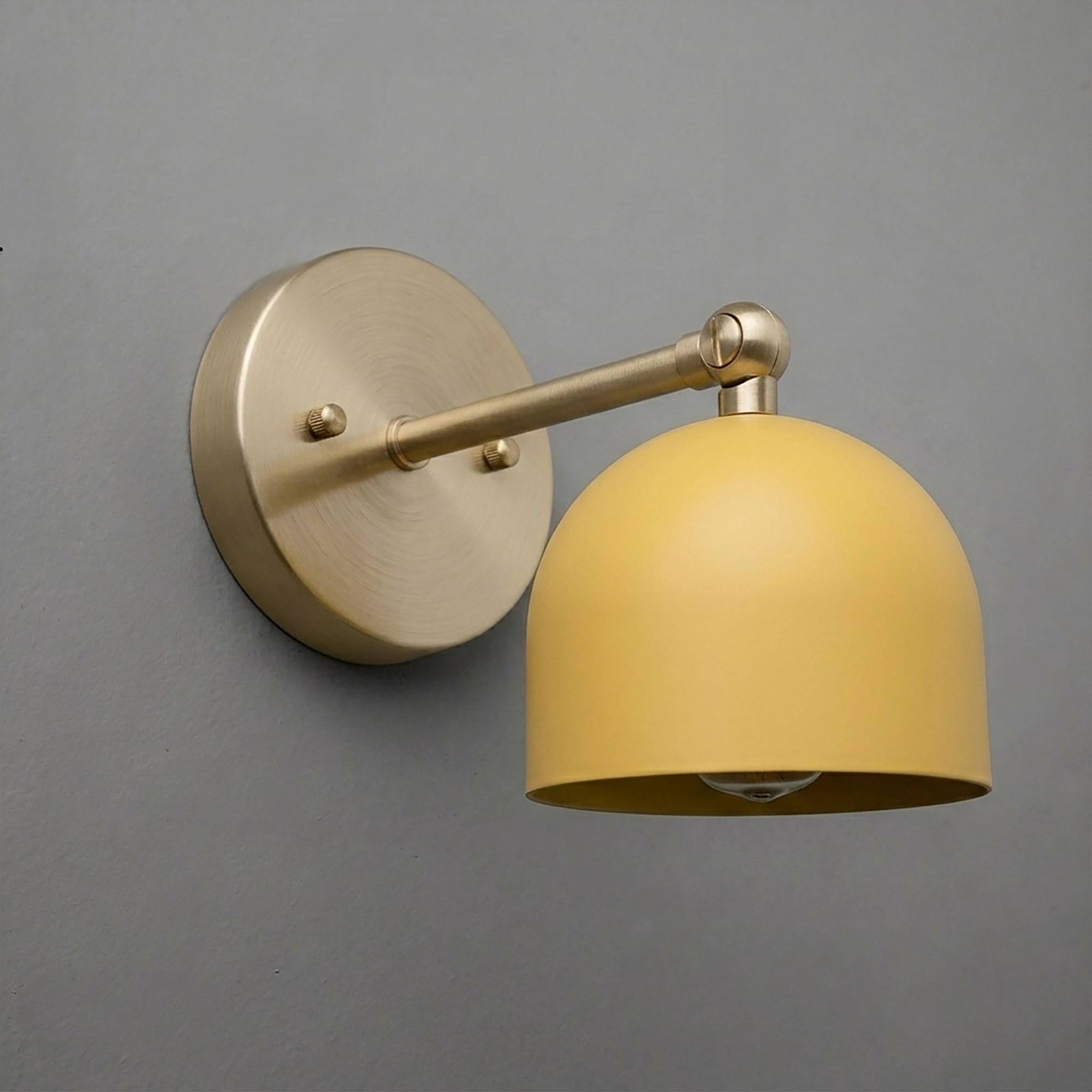 Brushed brass wall sconce with a matte mustard yellow dome-shaped shade and adjustable arm. - SCONCE MODEL NO. 5103