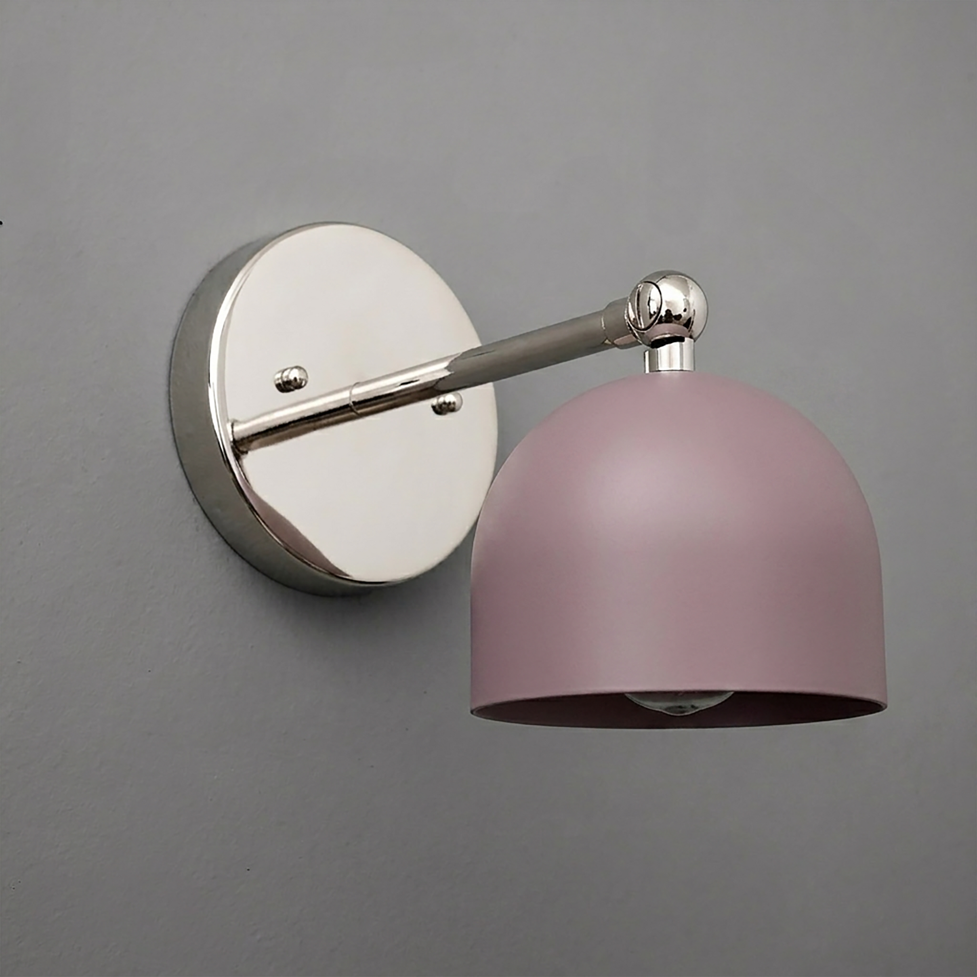 Wall-mounted sconce with a brushed nickel round base and arm, featuring a matte pink dome-shaped shade. - SCONCE MODEL NO. 5103