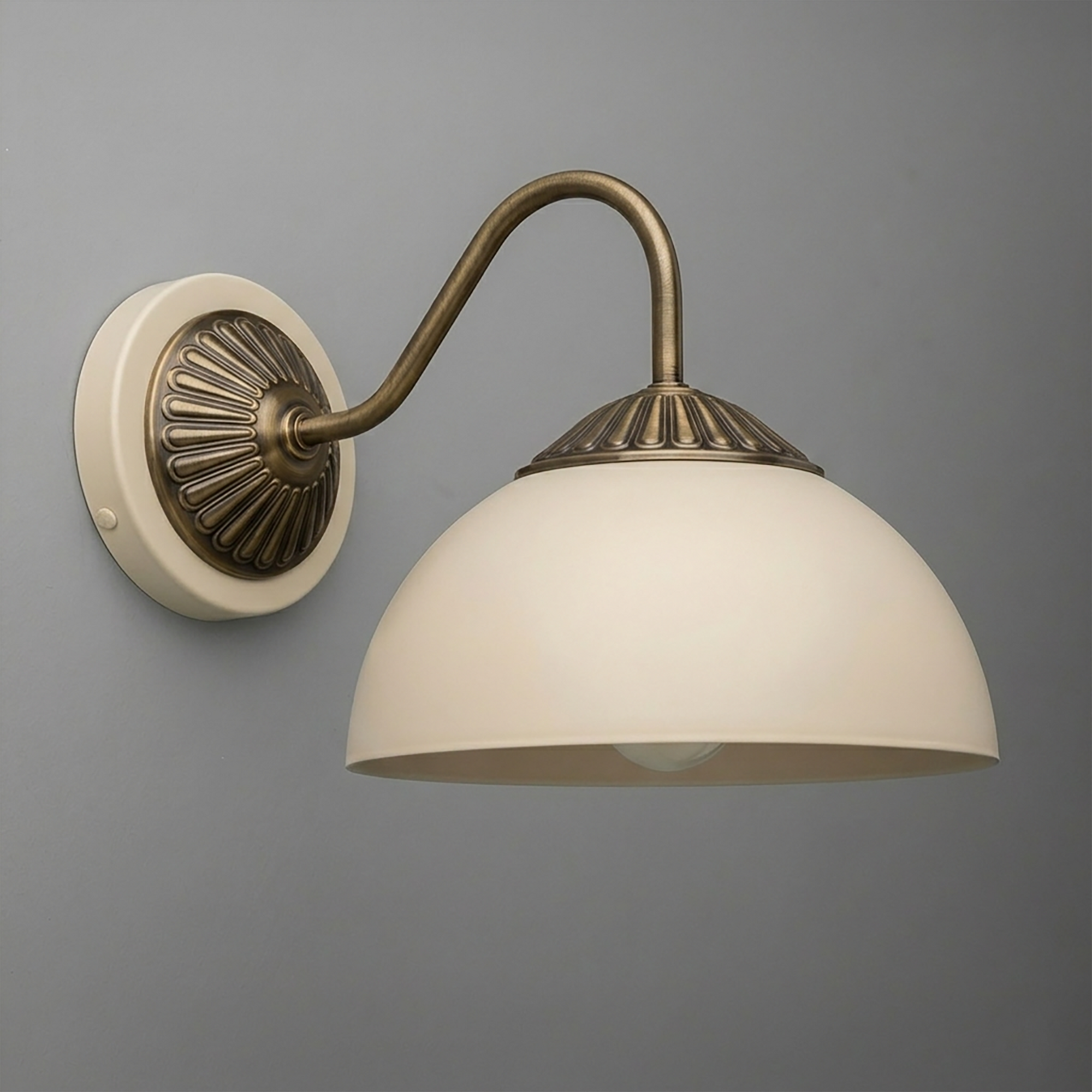 Wall-mounted sconce with antique brass curved arm and white frosted dome glass shade. - SCONCE MODEL NO. 9408