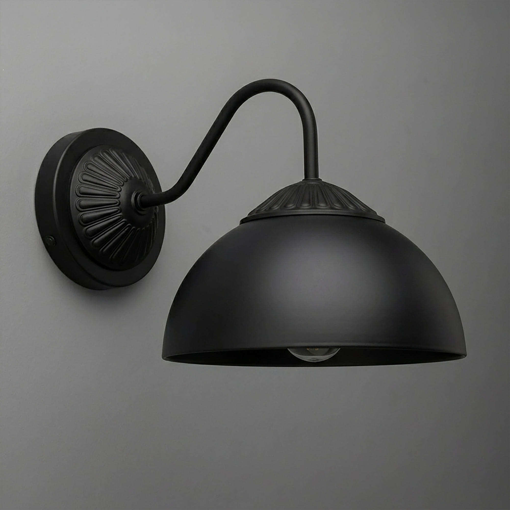 Matte black metal wall sconce with round backplate and curved arm supporting a dome-shaped shade. - SCONCE MODEL NO. 9408