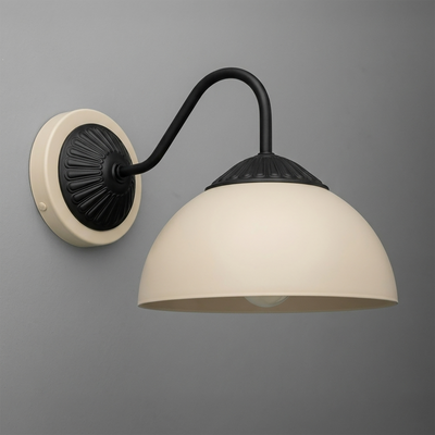 Black metal wall sconce with curved arm and matte cream dome shade mounting on round beige base. - SCONCE MODEL NO. 9408