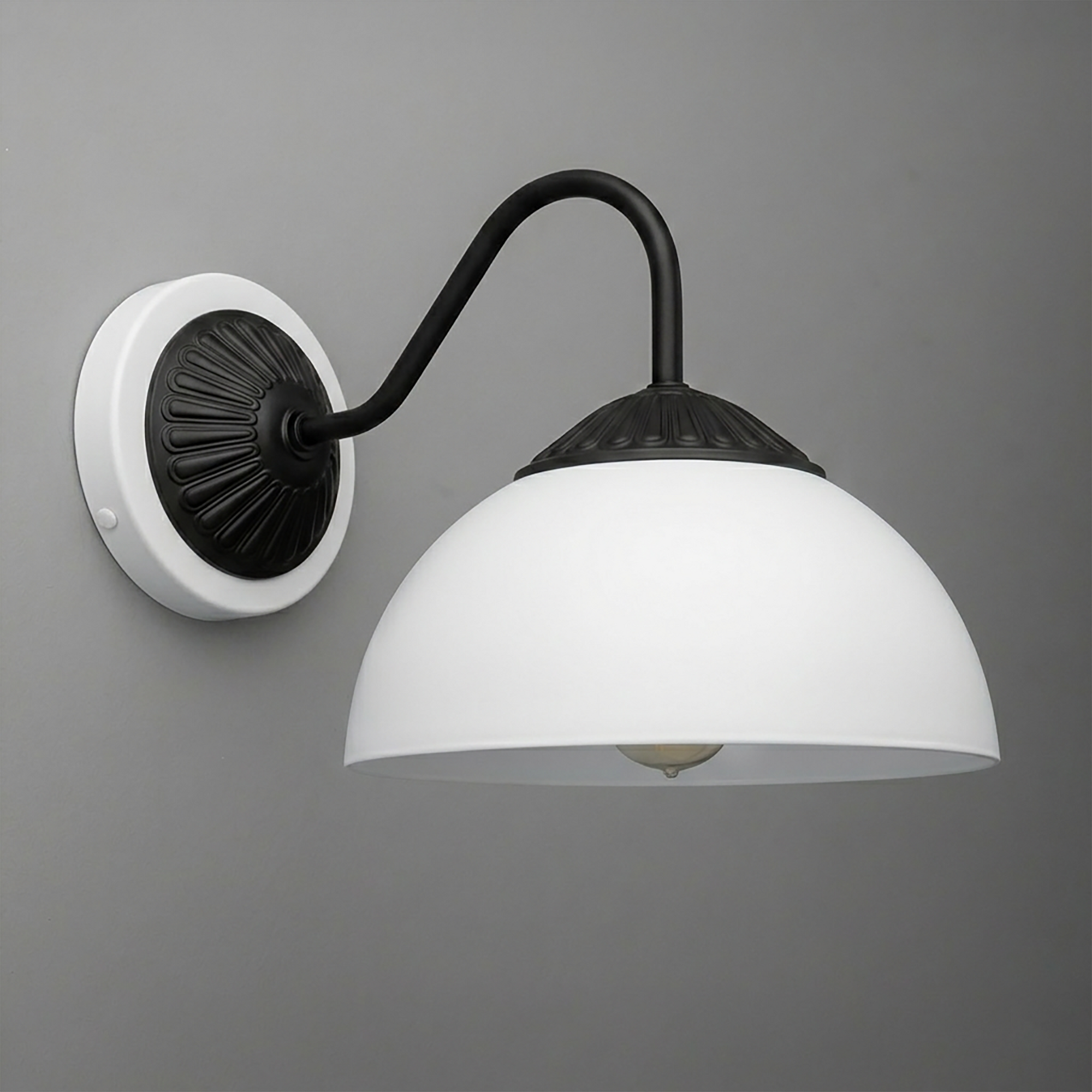 Black metal wall sconce with curved arm and white dome glass shade mounting on a white round base. - SCONCE MODEL NO. 9408