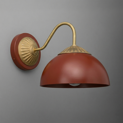 Wall sconce with matte rust red dome shade, antique brass curved arm, and decorative round wall plate. - SCONCE MODEL NO. 9408