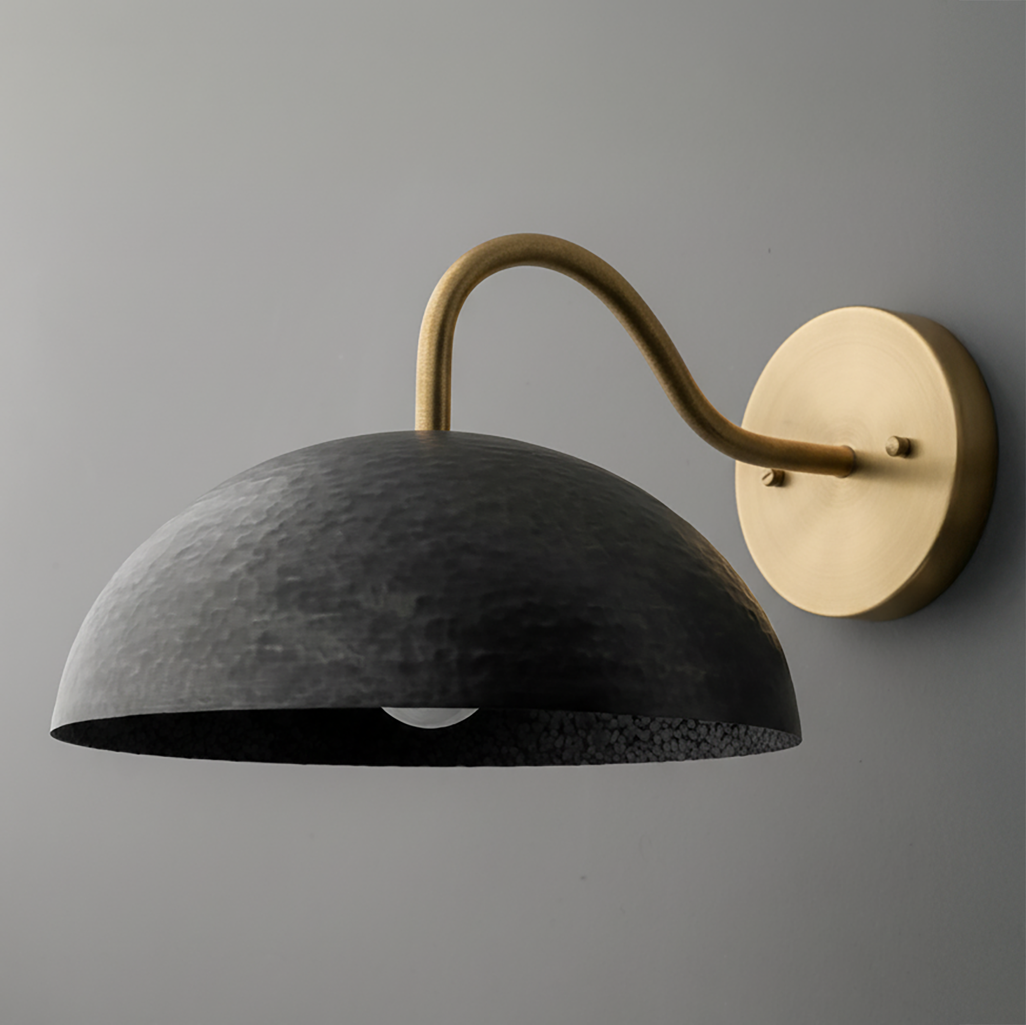 Wall sconce with hammered black dome shade and curved antique brass arm on round brass base. - SCONCE MODEL NO. 9874