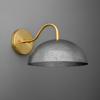 Wall sconce with aged steel hammered dome shade and curved antique brass arm mounting on round brass base. - SCONCE MODEL NO. 9874