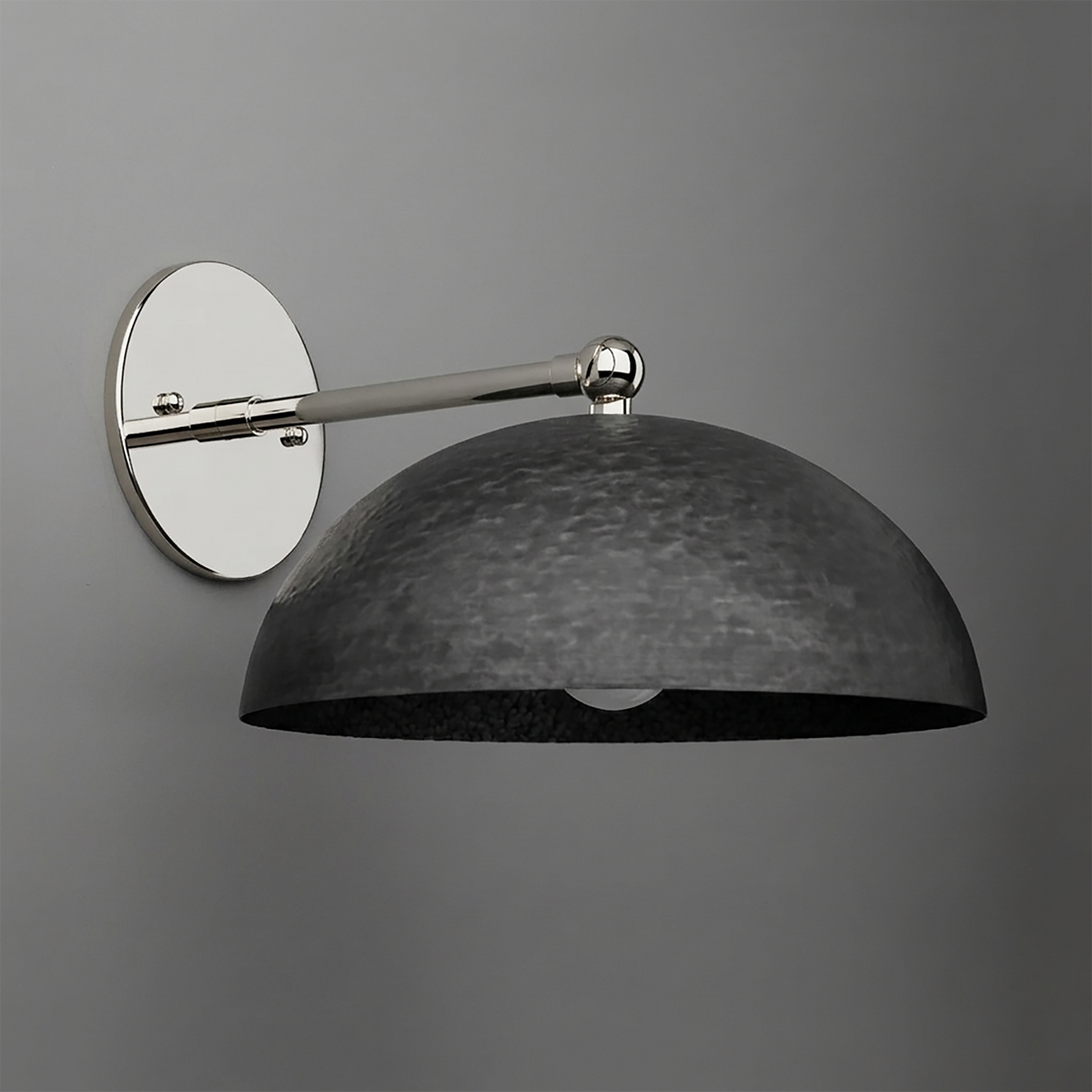 Wall-mounted sconce with a polished silver circular base and arm, featuring a large textured black metal dome shade. - SCONCE MODEL NO. 3164