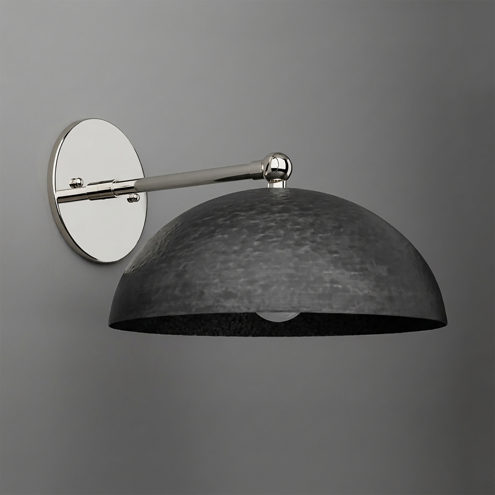 Wall-mounted sconce with a polished silver circular base and arm, featuring a large textured black metal dome shade. - SCONCE MODEL NO. 3164