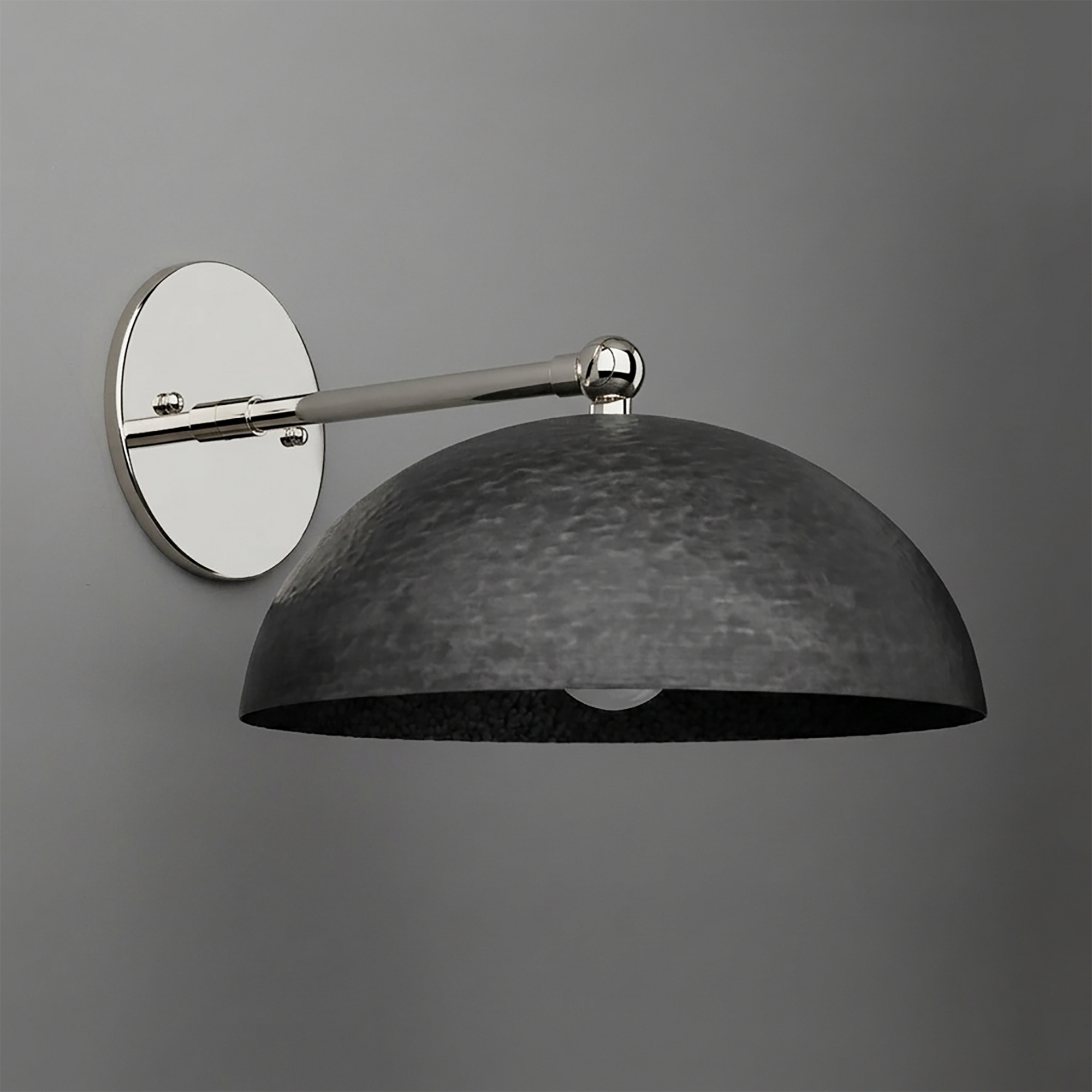 Wall-mounted sconce with a polished silver circular base and arm, featuring a large textured black metal dome shade. - SCONCE MODEL NO. 3164