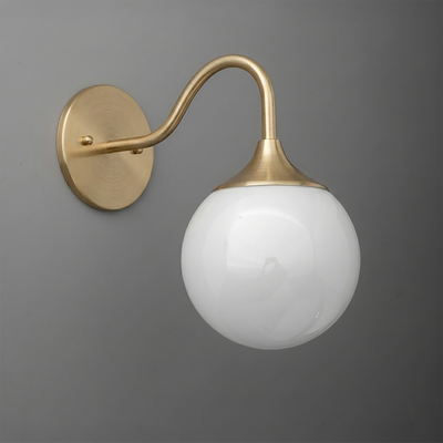 Wall sconce with brushed brass finish, curved arm, and large white frosted glass globe shade. - SCONCE MODEL NO. 8734