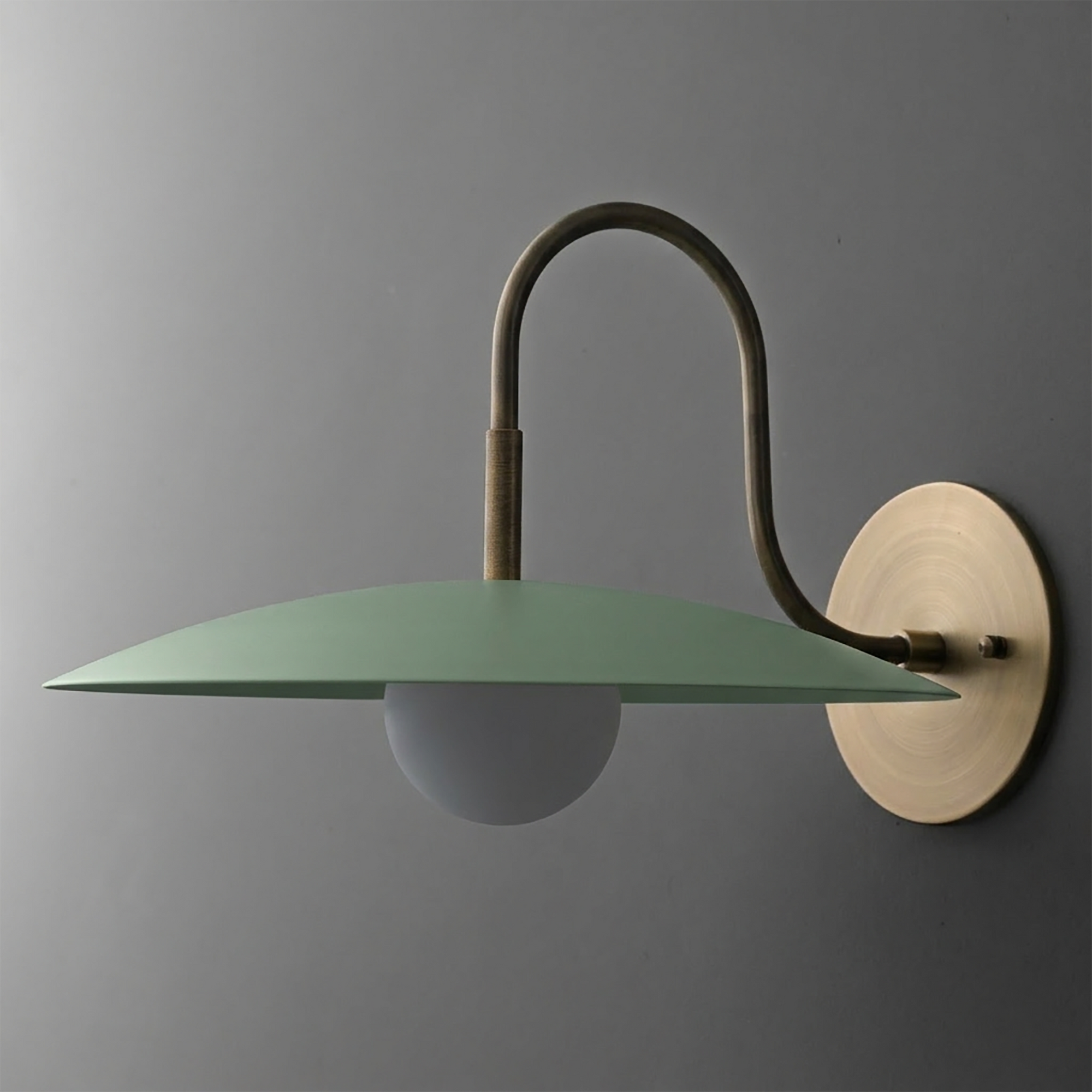 Matte green wide disc-shaped metal shade sconce with frosted globe bulb and brass curved arm mount. - SCONCE MODEL NO. 9171