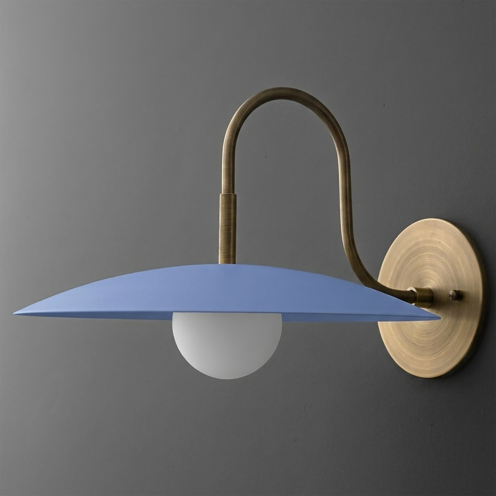 Wall sconce with matte blue disc shade, frosted white globe bulb, and brushed brass curved arm and round mount. - SCONCE MODEL NO. 9171