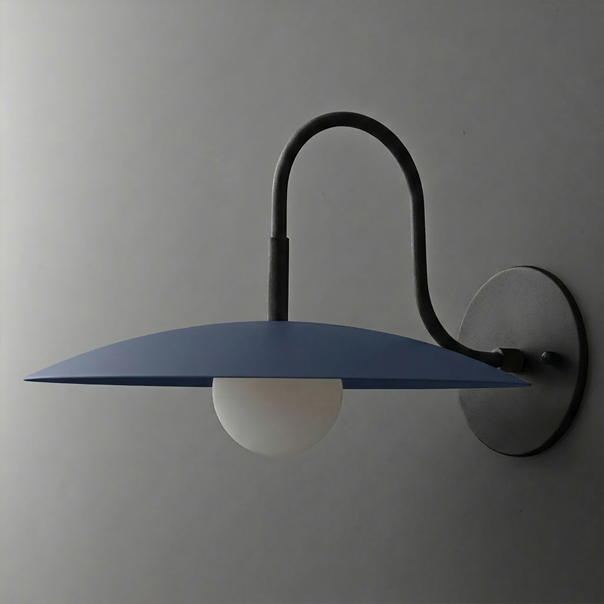 Wall-mounted black metal sconce with curved arm and wide flat blue shade over white globe bulb. - SCONCE MODEL NO. 9171