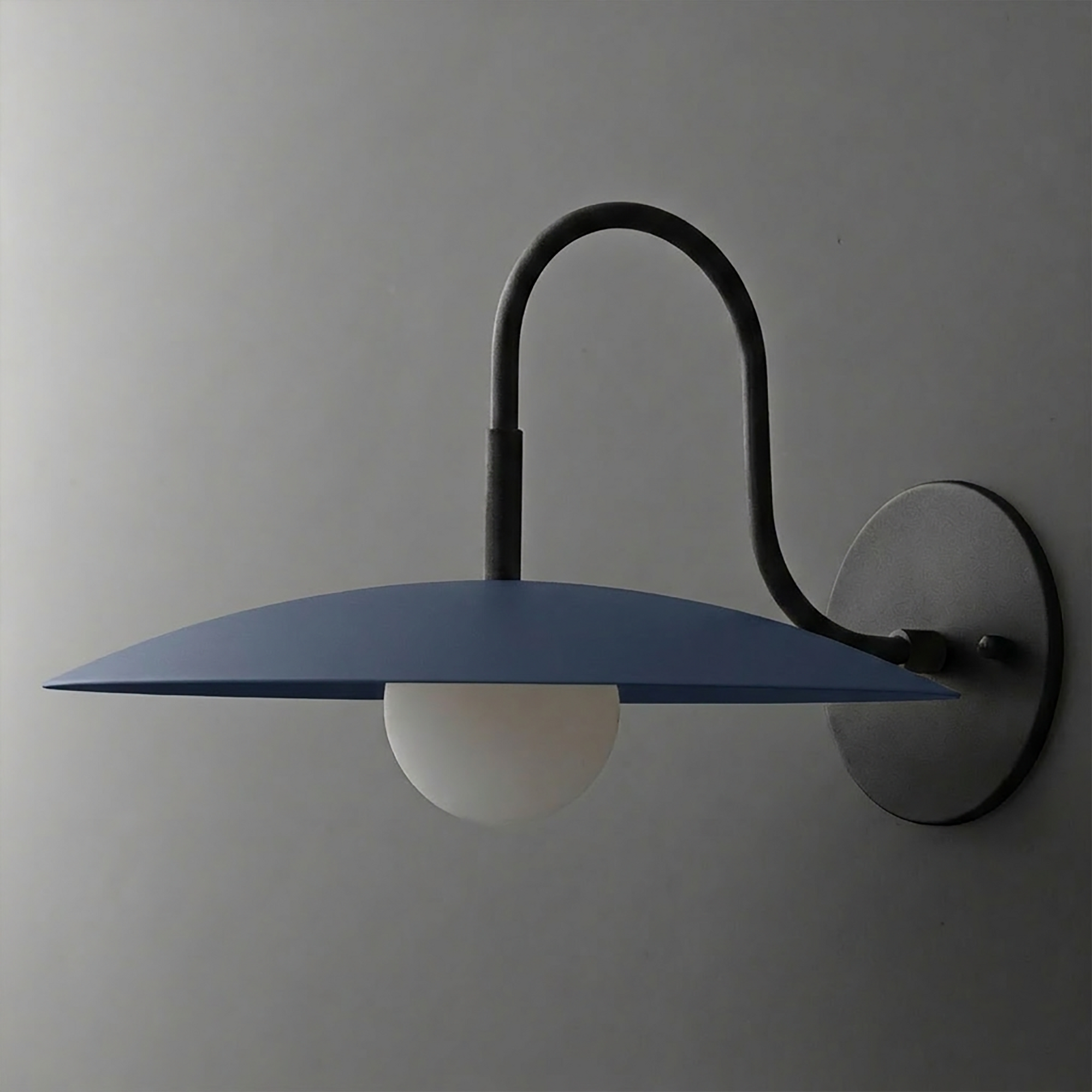 Wall-mounted black metal sconce with curved arm and wide flat blue shade over white globe bulb. - SCONCE MODEL NO. 9171