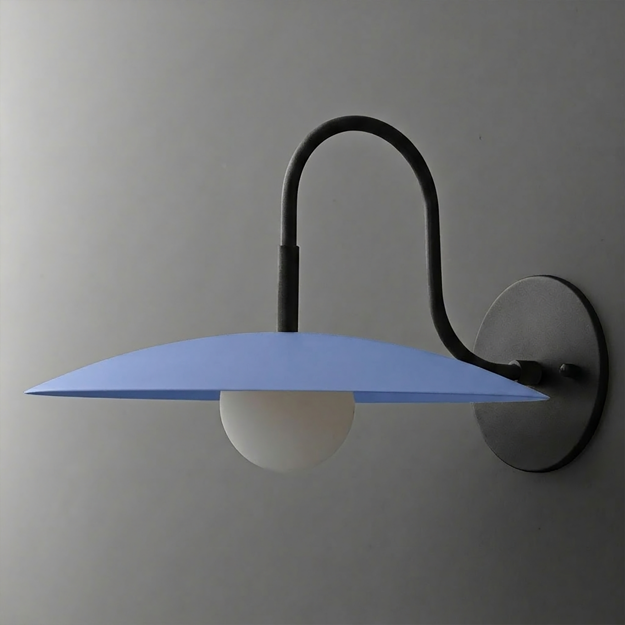 Wall sconce with matte black curved arm and round light blue disc shade over frosted white globe bulb. - SCONCE MODEL NO. 9171