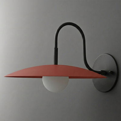 Matte black metal wall sconce with curved arm, rust-colored flat disc shade, and frosted globe bulb. - SCONCE MODEL NO. 9171