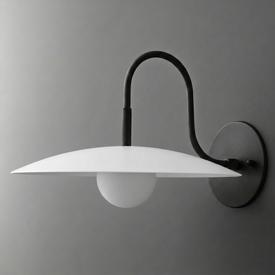 Black metal wall sconce with curved arm, flat white disc shade, and round frosted bulb. - SCONCE MODEL NO. 9171