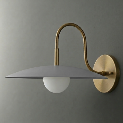 Wall sconce with brass curved arm and round backplate, featuring a matte gray, wide flat shade and frosted globe bulb. - SCONCE MODEL NO. 9171