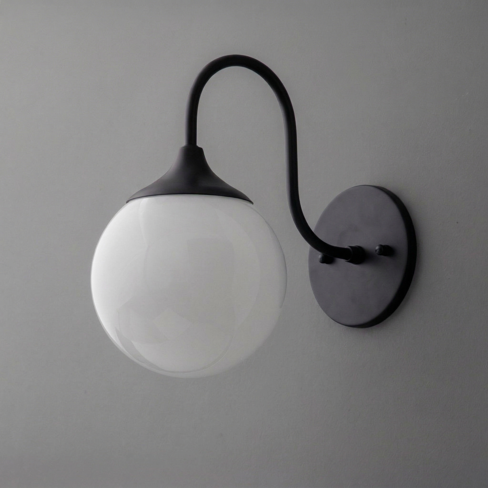 Wall sconce with matte black curved arm and round white glass globe shade. - SCONCE MODEL NO. 3961