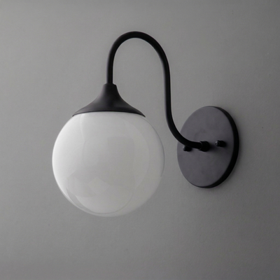 Wall sconce with matte black curved arm and round white glass globe shade. - SCONCE MODEL NO. 3961