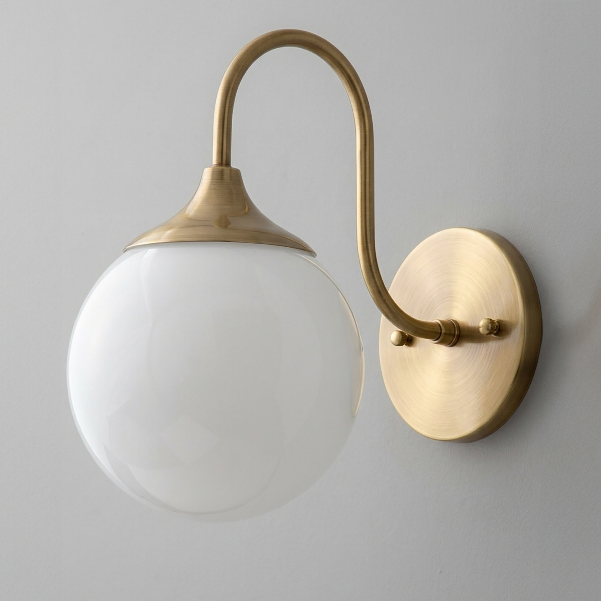 Wall sconce with brushed brass finish, curved arm, and white frosted glass globe shade. - SCONCE MODEL NO. 3961