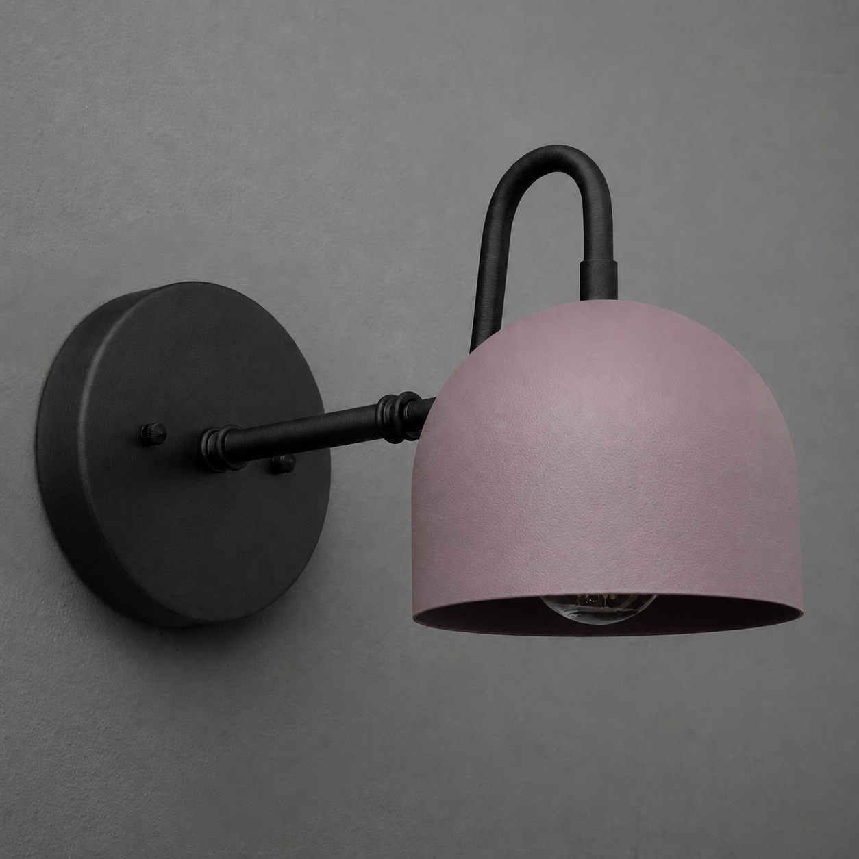 Matte black metal wall sconce with curved arm and dome-shaped muted pink shade, single bulb design. - SCONCE MODEL NO. 3628