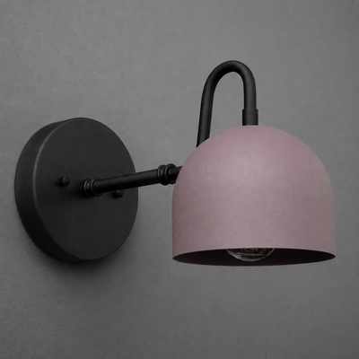 Matte black metal wall sconce with curved arm and dome-shaped muted pink shade, single bulb design. - SCONCE MODEL NO. 3628