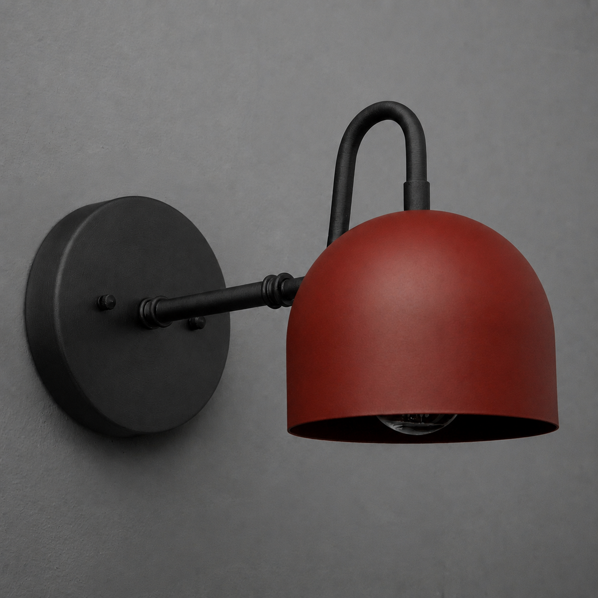 Wall-mounted sconce with matte black arm and round base, featuring a dome-shaped rust-red metal shade. - SCONCE MODEL NO. 3628