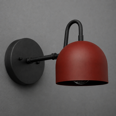 Wall-mounted sconce with matte black arm and round base, featuring a dome-shaped rust-red metal shade. - SCONCE MODEL NO. 3628