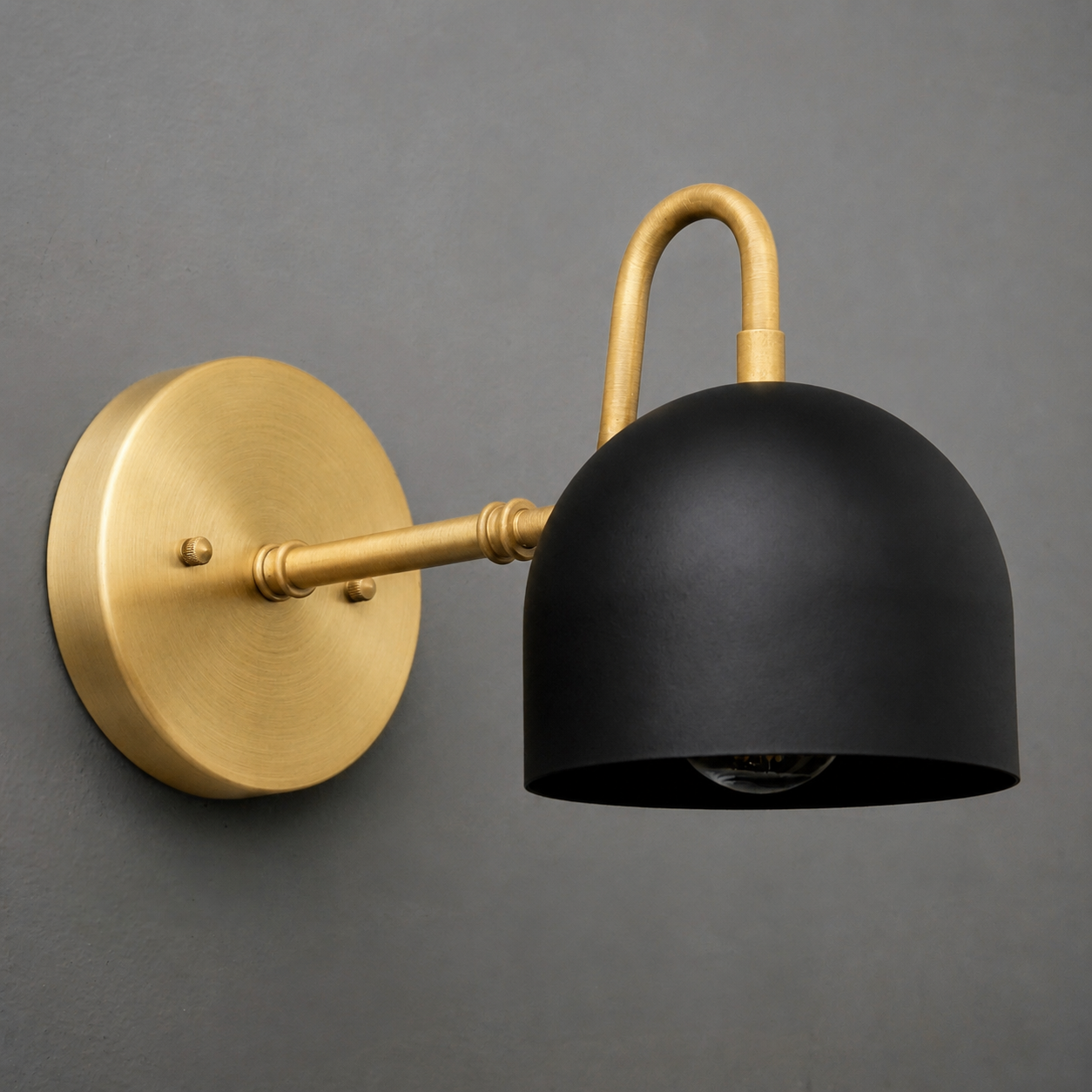 Wall sconce with matte black dome shade and brushed brass curved arm and round wall mount. - SCONCE MODEL NO. 3628