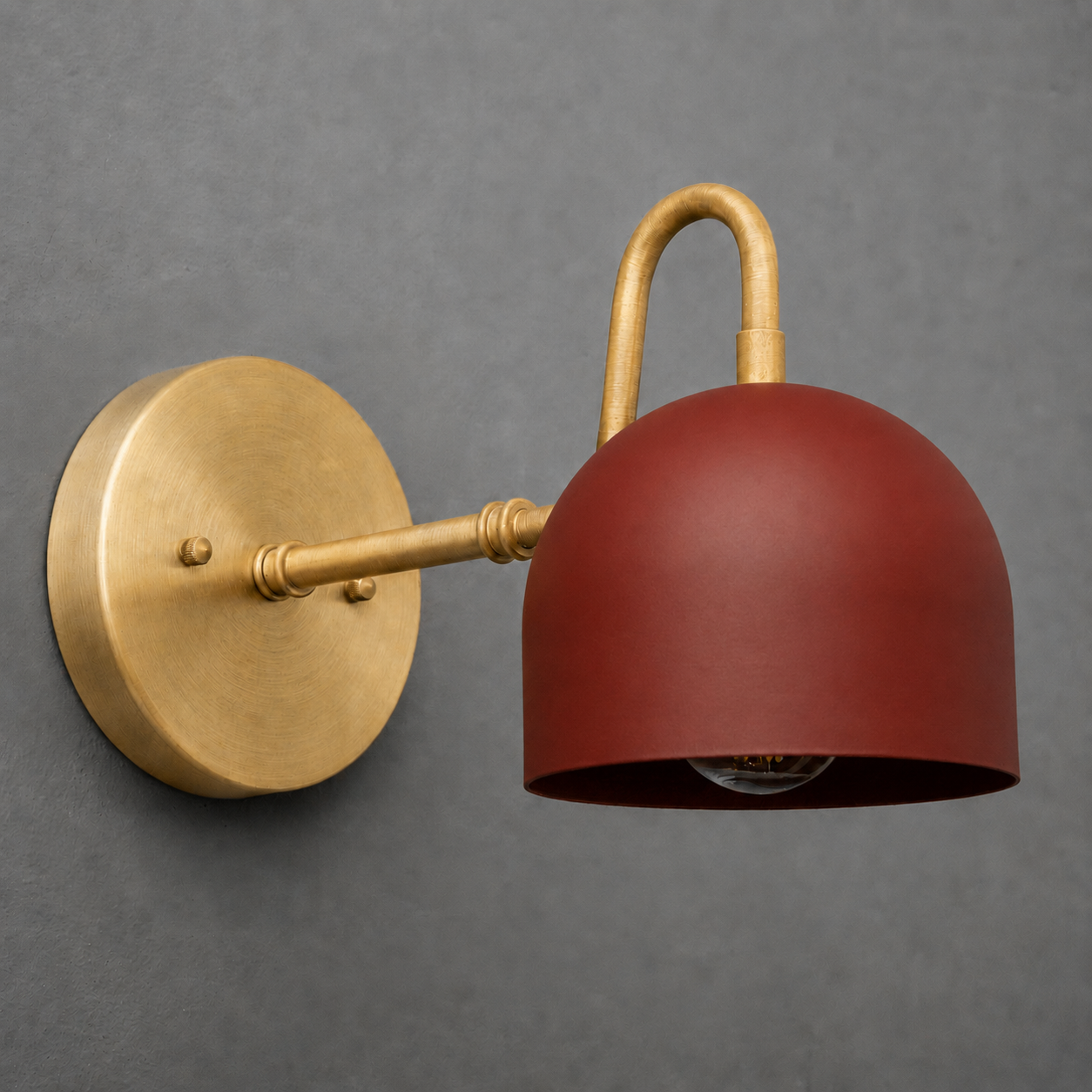 Wall-mounted sconce with a brass finish arm and base, featuring a matte red dome-shaped metal shade. - SCONCE MODEL NO. 3628