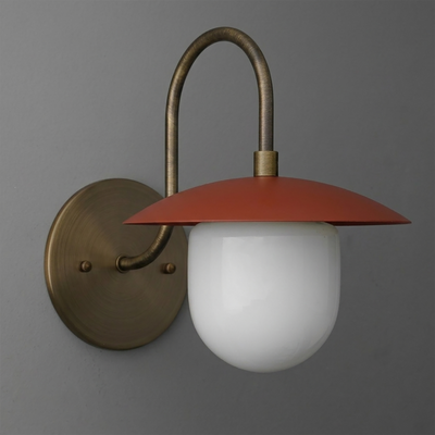 Wall-mounted sconce with aged brass curved arm, round backplate, rust-red flat metal shade, and white frosted glass globe. - SCONCE MODEL NO. 7191