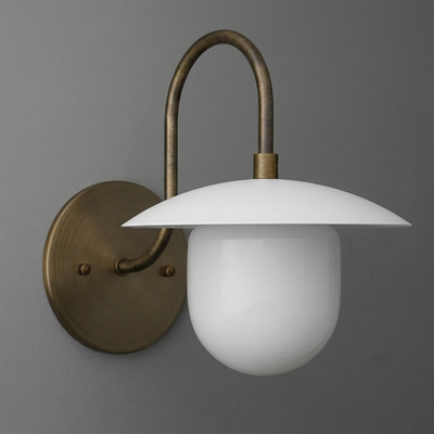 Wall sconce with a curved antique brass arm and round base, featuring a white dome-shaped glass shade and diffuser. - SCONCE MODEL NO. 7191
