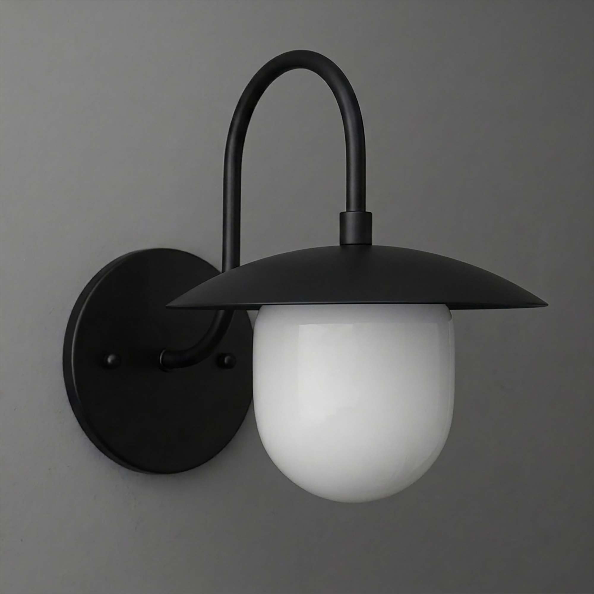 Matte black metal wall sconce with curved arm and white frosted glass globe shade. - SCONCE MODEL NO. 7191