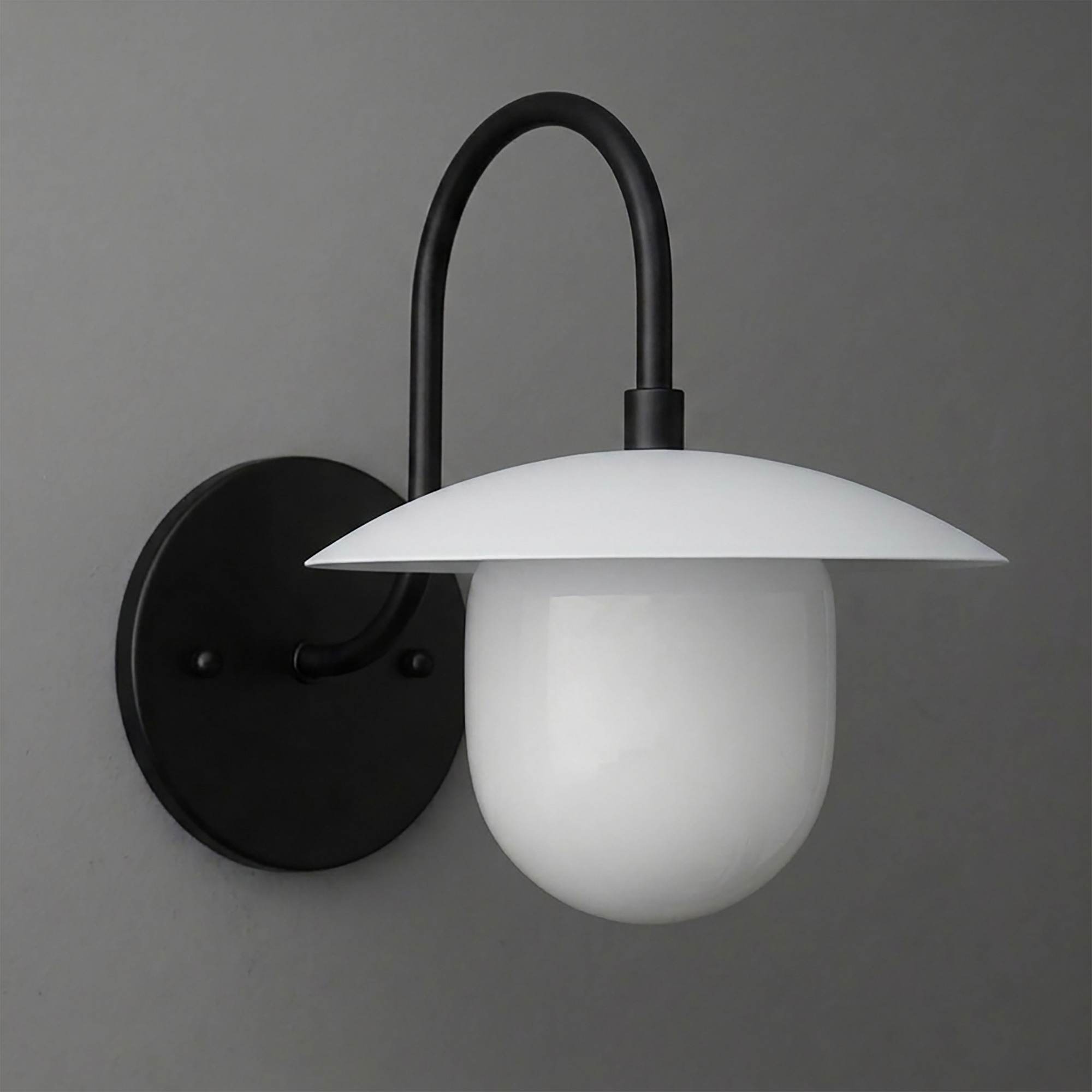 Black metal wall sconce with curved arm and white dome-shaped glass shade. - SCONCE MODEL NO. 7191