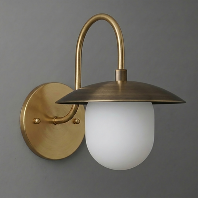 Wall sconce with brushed brass finish, curved arm, flat disc shade, and frosted glass bulb cover. - SCONCE MODEL NO. 7191