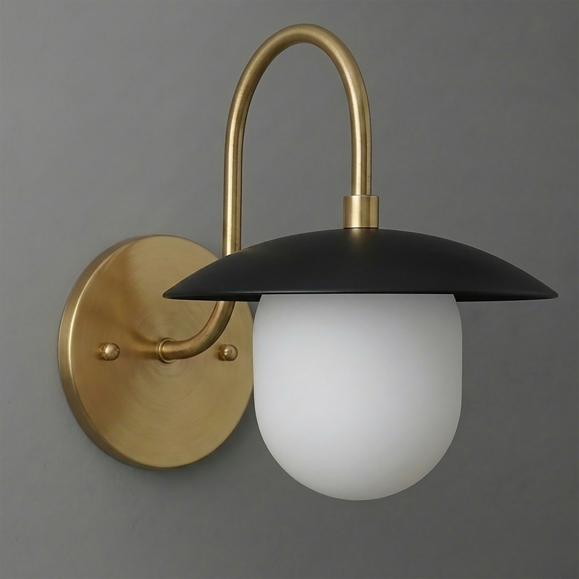 Matte black dome shade sconce with frosted white glass bulb and brushed brass curved arm and round wall plate. - SCONCE MODEL NO. 7191