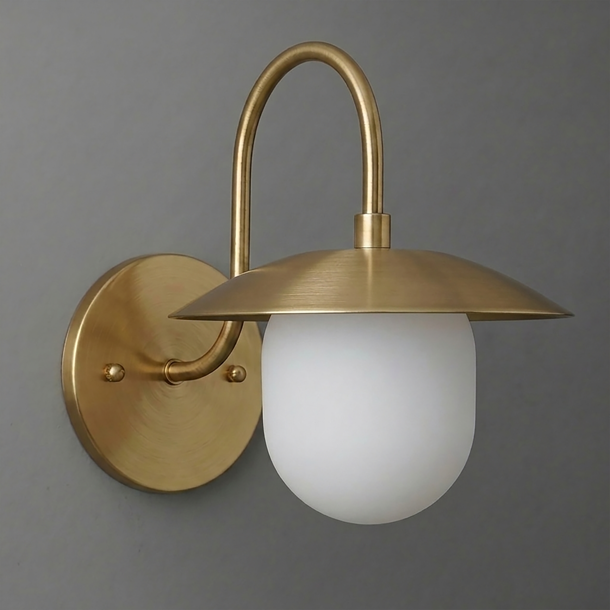 Wall-mounted brass sconce with a curved arm and frosted glass globe shade. - SCONCE MODEL NO. 7191