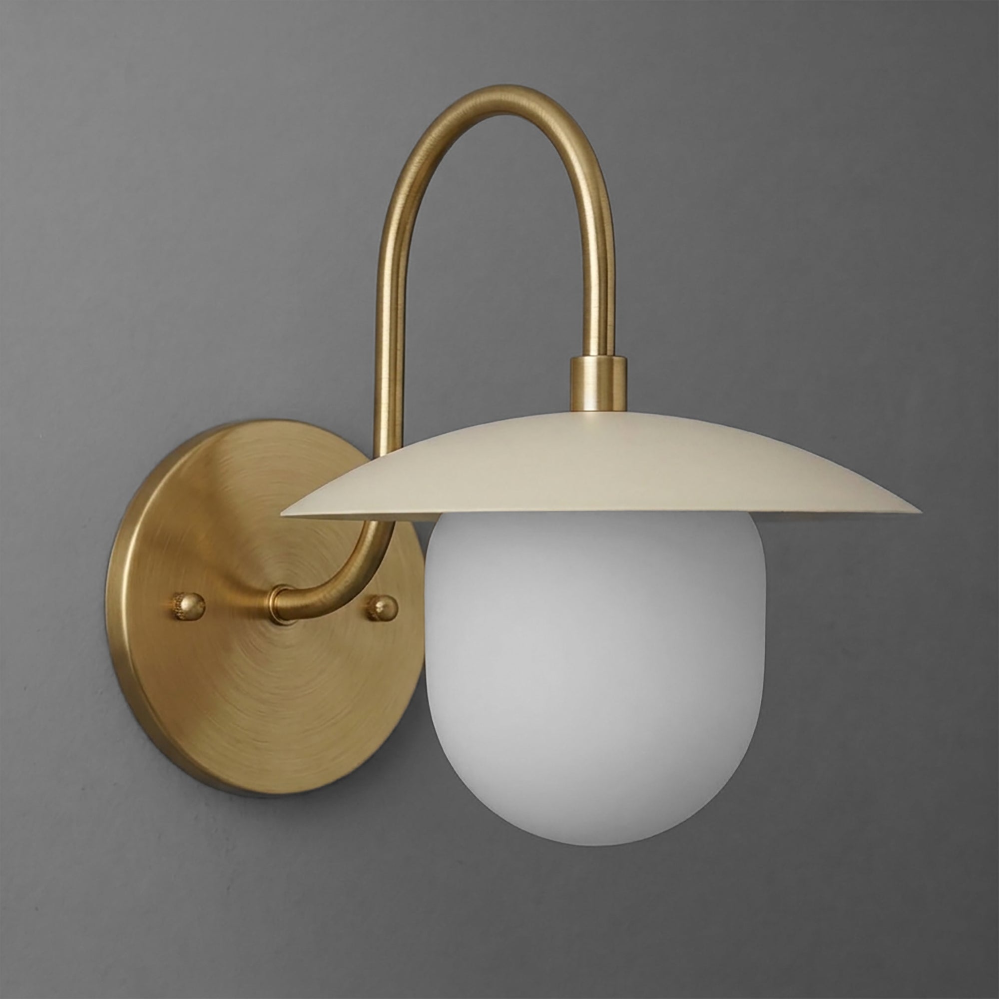 Matte brass wall sconce with curved arm and frosted white glass globe shade. - SCONCE MODEL NO. 7191
