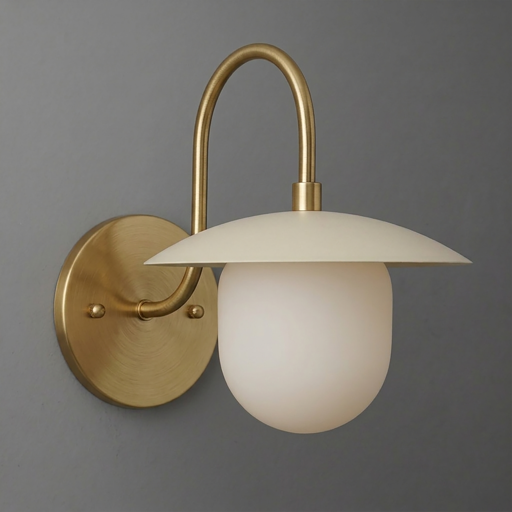 Wall sconce with brushed brass finish, curved arm, and matte white mushroom-shaped glass shade. - SCONCE MODEL NO. 7191