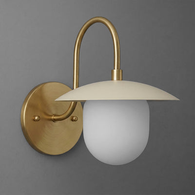 Matte brass wall sconce with curved arm and frosted white glass globe shade. - SCONCE MODEL NO. 7191