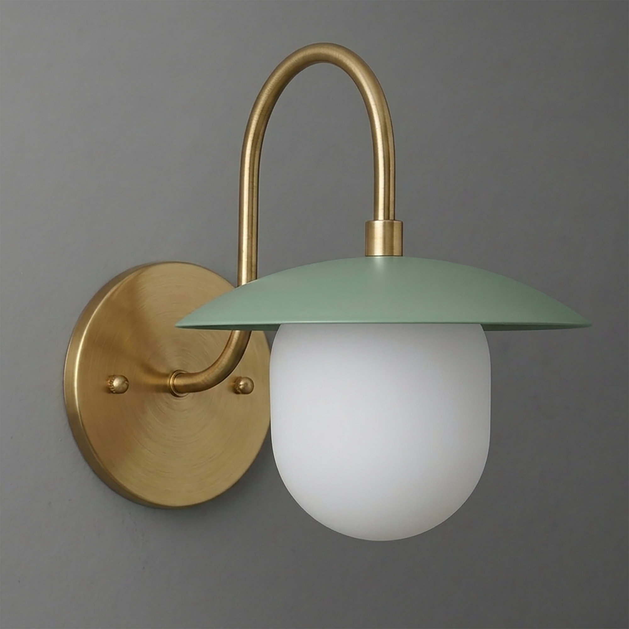 Brushed brass wall sconce with curved arm, matte green metal shade, and frosted white glass bulb cover. - SCONCE MODEL NO. 7191