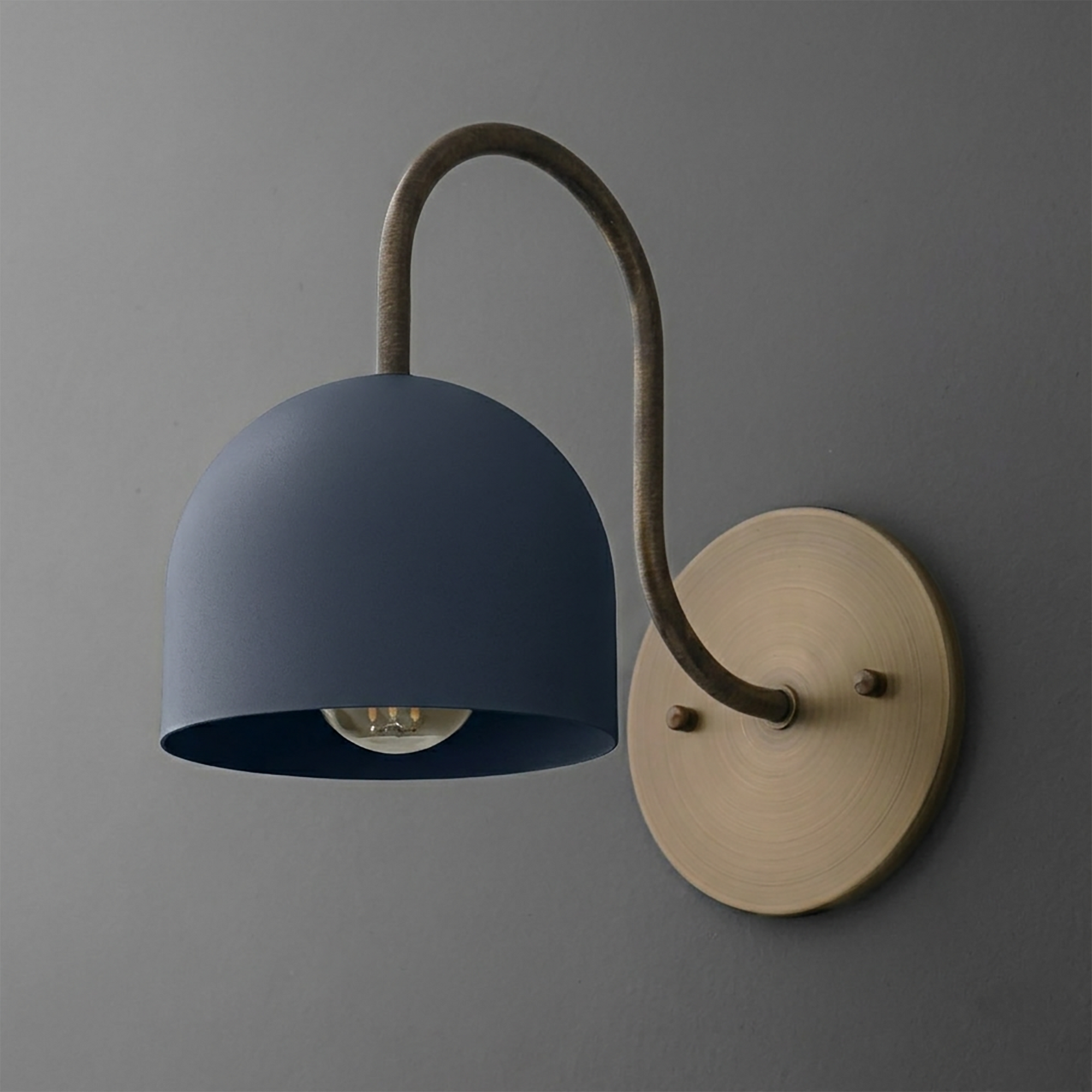 Wall-mounted sconce with matte blue dome shade, curved brass arm, and circular brass base plate. - SCONCE MODEL NO. 6308