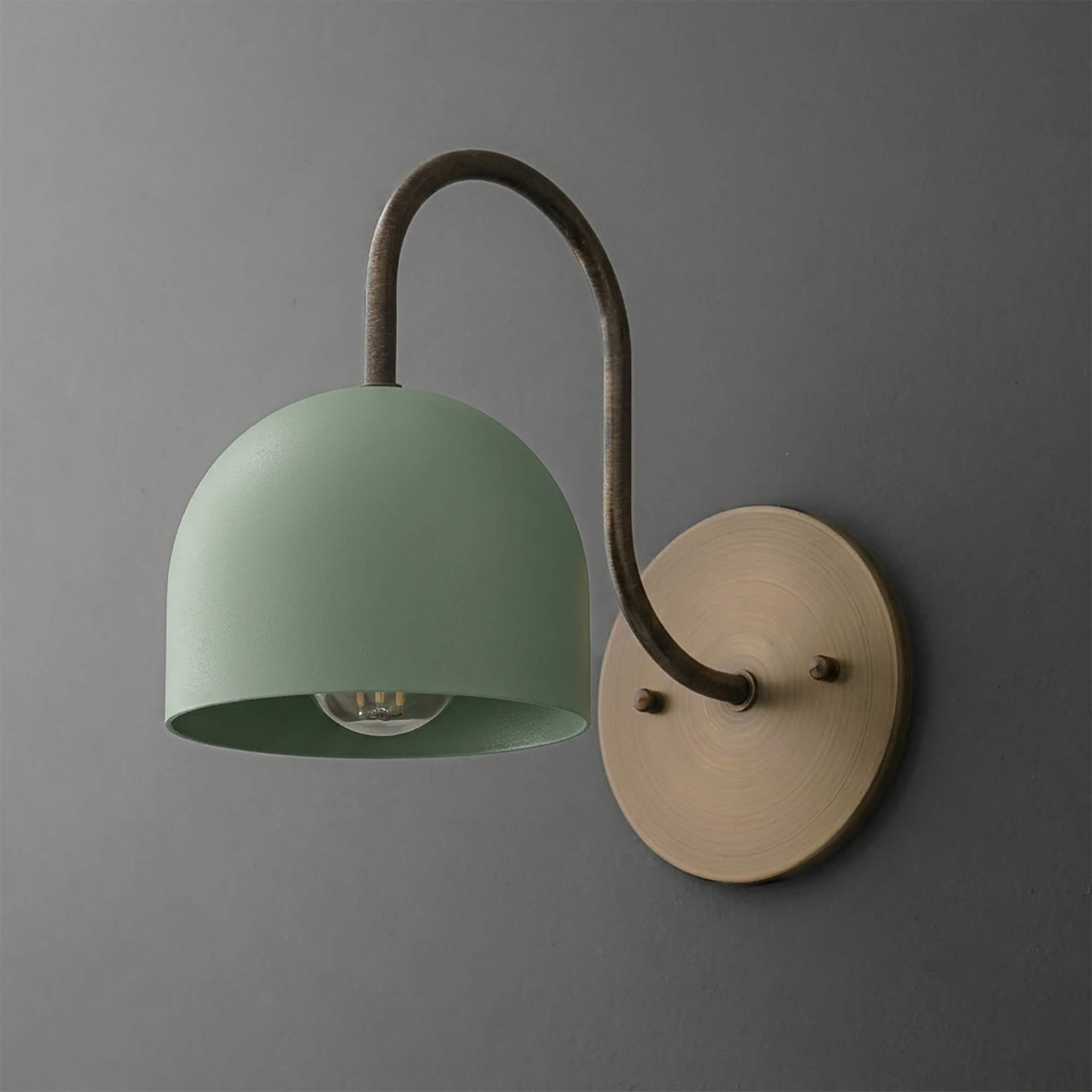 Matte green dome-shaped metal sconce with exposed bulb, curved dark bronze arm, and round brass wall plate. - SCONCE MODEL NO. 6308