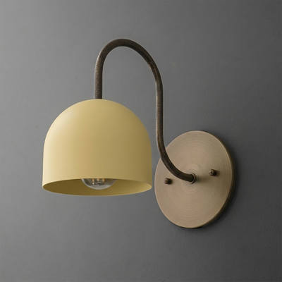 Wall-mounted sconce with matte yellow dome shade and curved dark metal arm attaching to round brass backplate. - SCONCE MODEL NO. 6308
