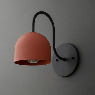 Matte black metal sconce with curved arm and rust-orange dome-shaped shade covering one bulb. - SCONCE MODEL NO. 6308