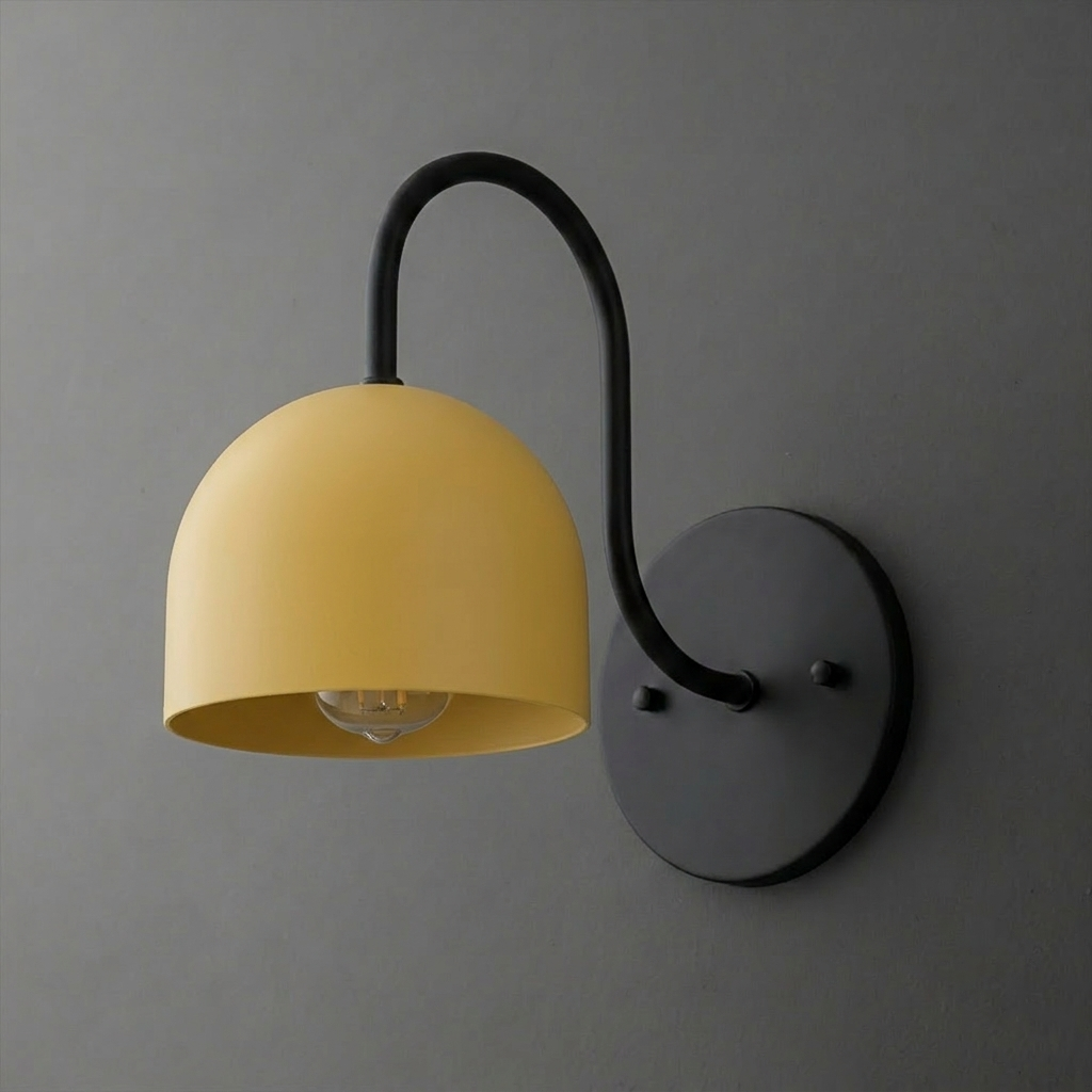 Wall-mounted sconce with matte black metal arm and round base, featuring a smooth, dome-shaped yellow shade. - SCONCE MODEL NO. 6308
