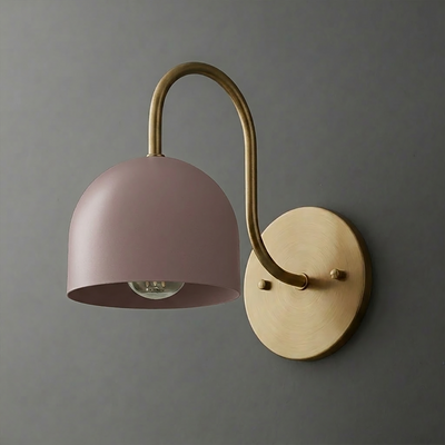 Wall sconce with curved brass arm and matte pink dome-shaped metal shade covering single bulb. - SCONCE MODEL NO. 6308