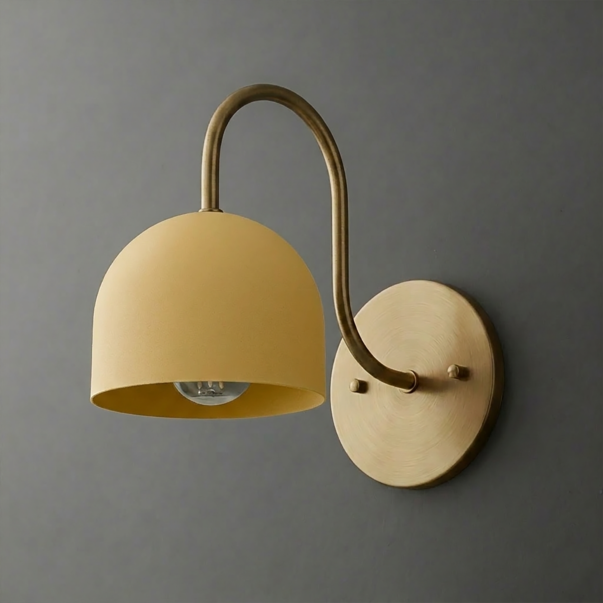 Matte mustard yellow dome-shaped metal sconce with curved bronze arm and round wall mount. - SCONCE MODEL NO. 6308