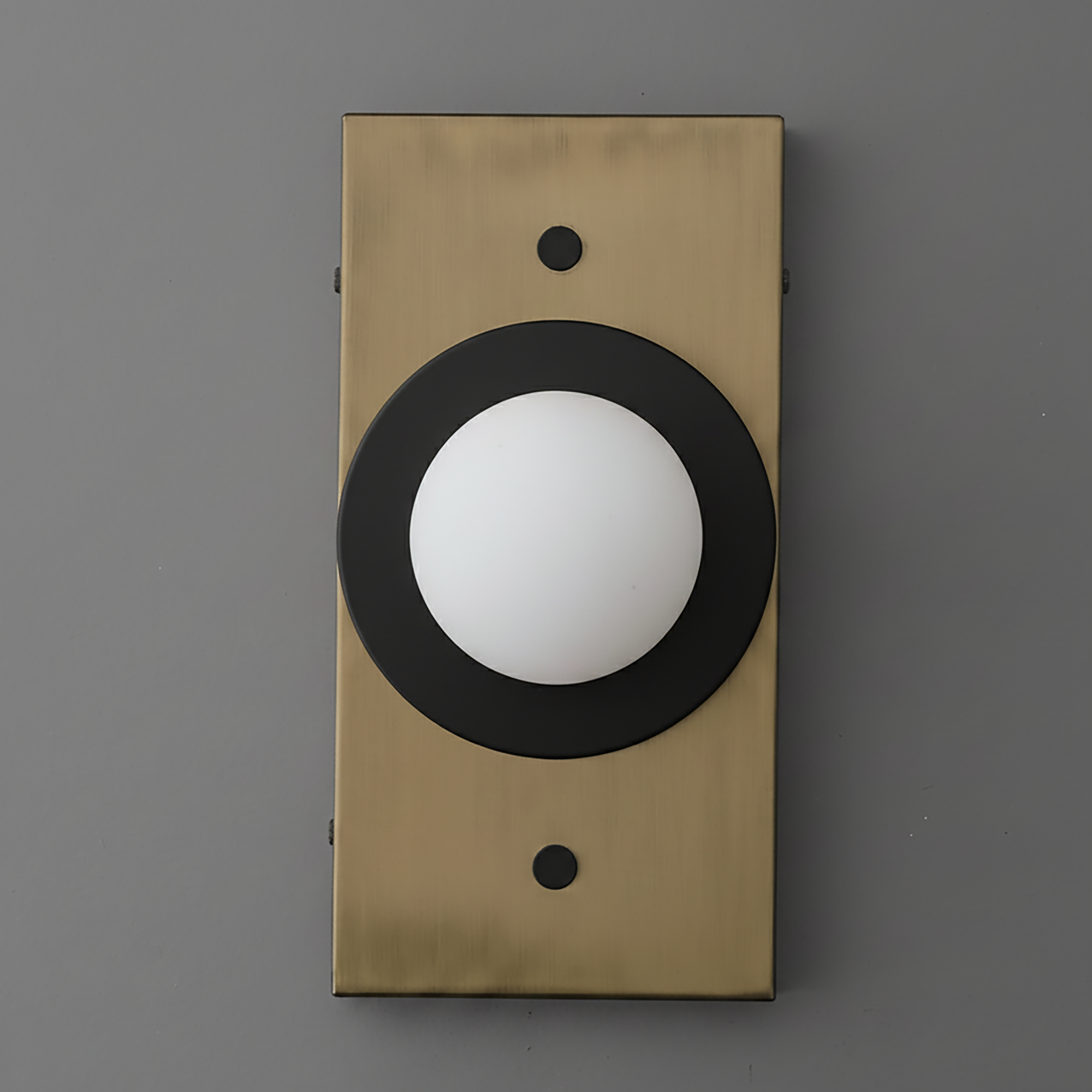Wall sconce with antique brass rectangular backplate and black circular trim around white globe light. - SCONCE MODEL NO. 4474